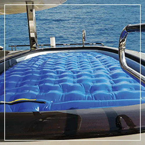 Blue quilted FunAir inflatable pool filler panel with stainless steel hardware on open water
