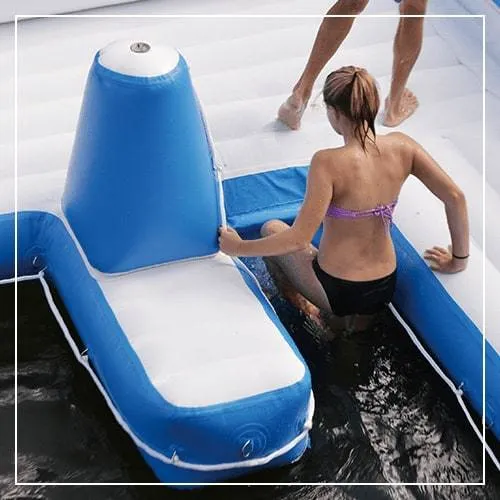 Woman using FunAir patented SeaStairs cone step to climb from the water onto an inflatable jet ski dock platform