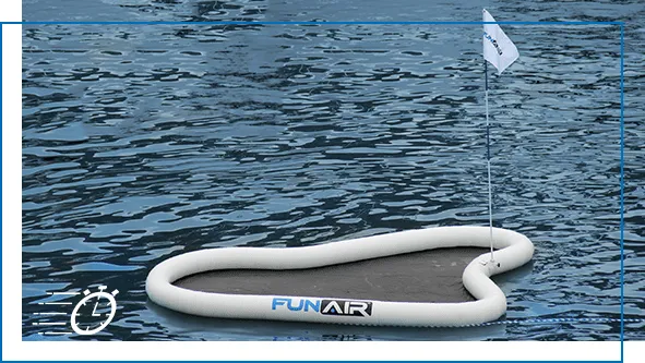 FunAir inflatable yacht golf green floating on open water with flag and pole, viewed from above