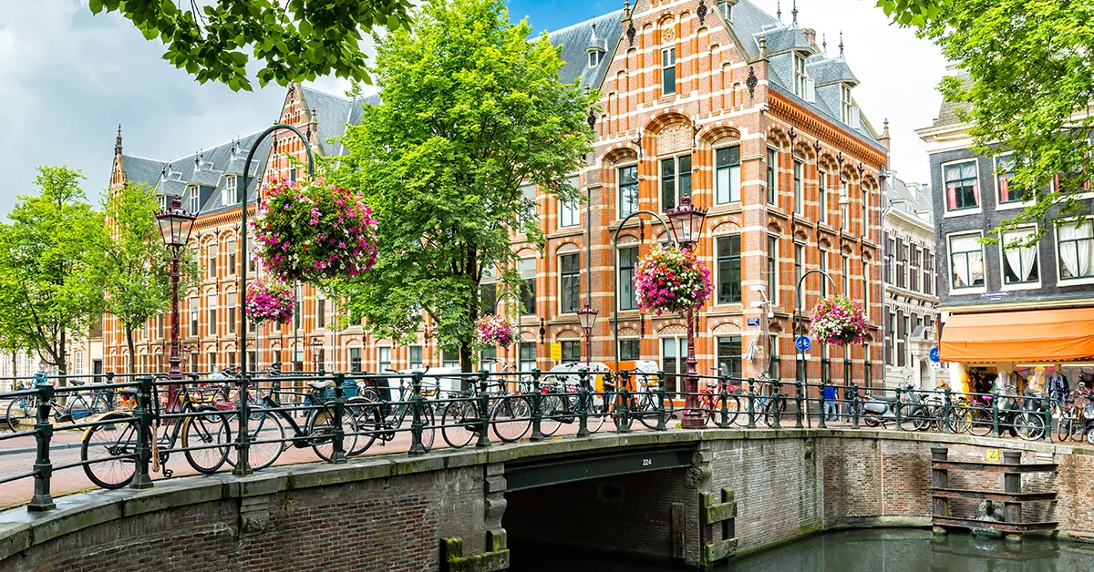 A Yachtie’s Guide to Amsterdam view of buildings and bridge over canal visited by superyacht crew