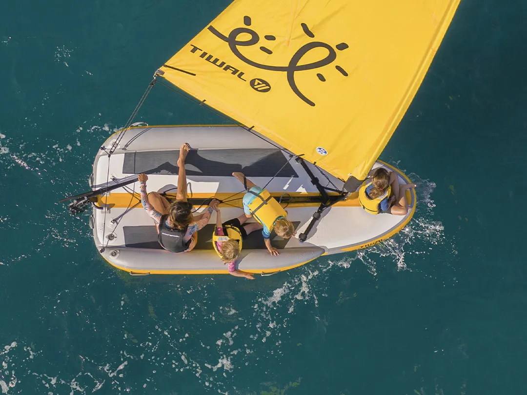 Drone view of charter yacht guests in a Tiwal dinghy
