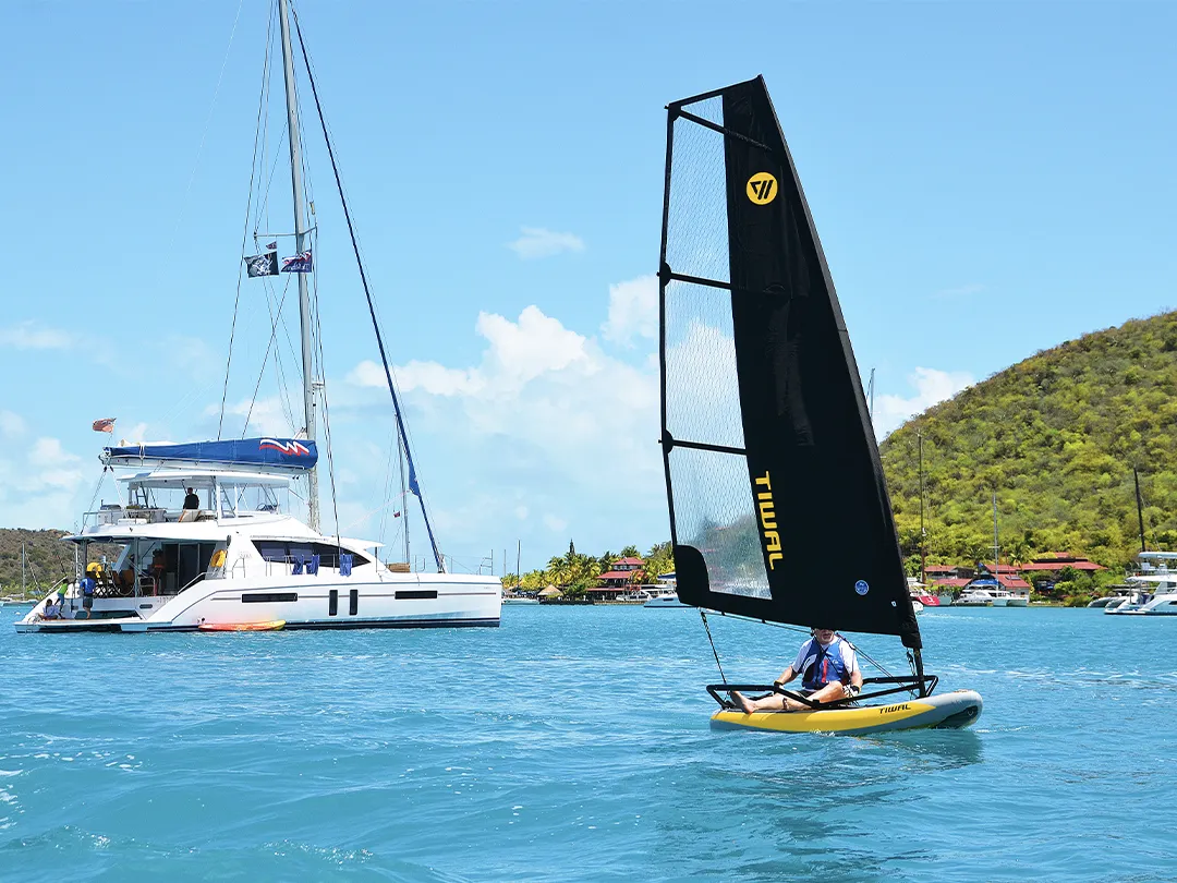 Tiwal inflatable dinghy with a catamaran in the background
