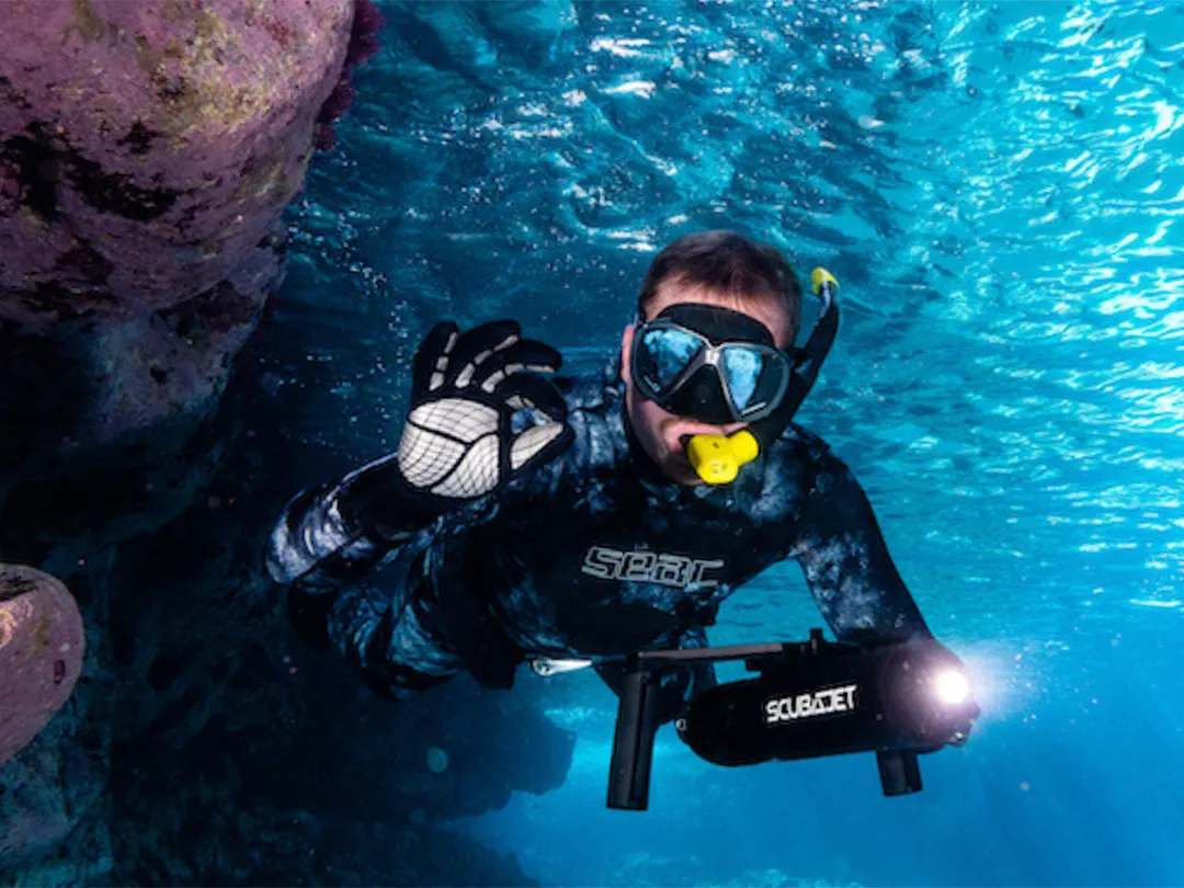Yacht guest SCUBA diving with a SCUBAJET