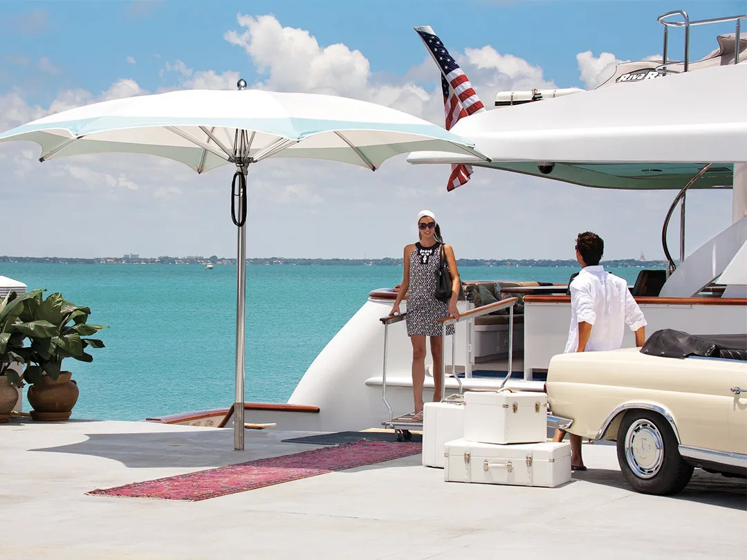 Superyacht charter guest disembarking the boat under a TUUCI shade