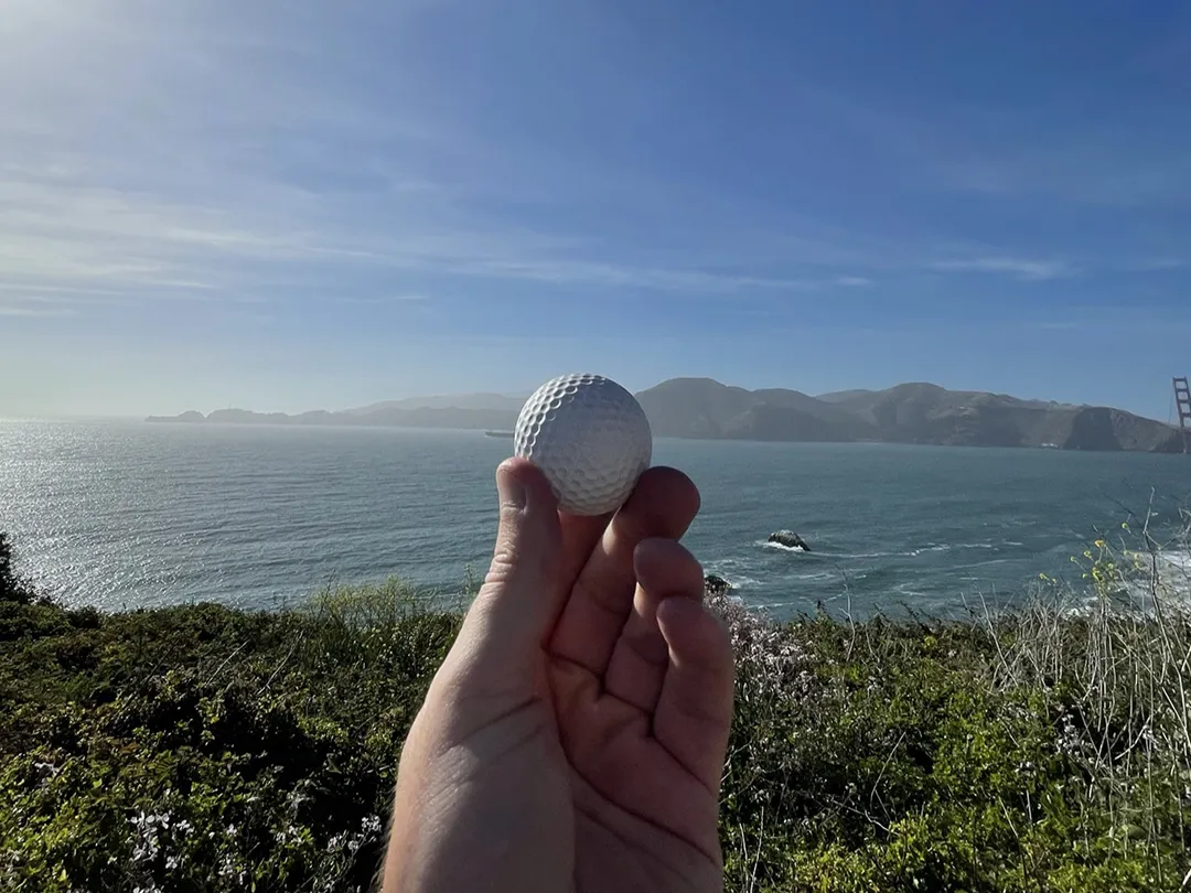 Charter-yacht-crew-member-holding-Biodegradable-Golf-Ball