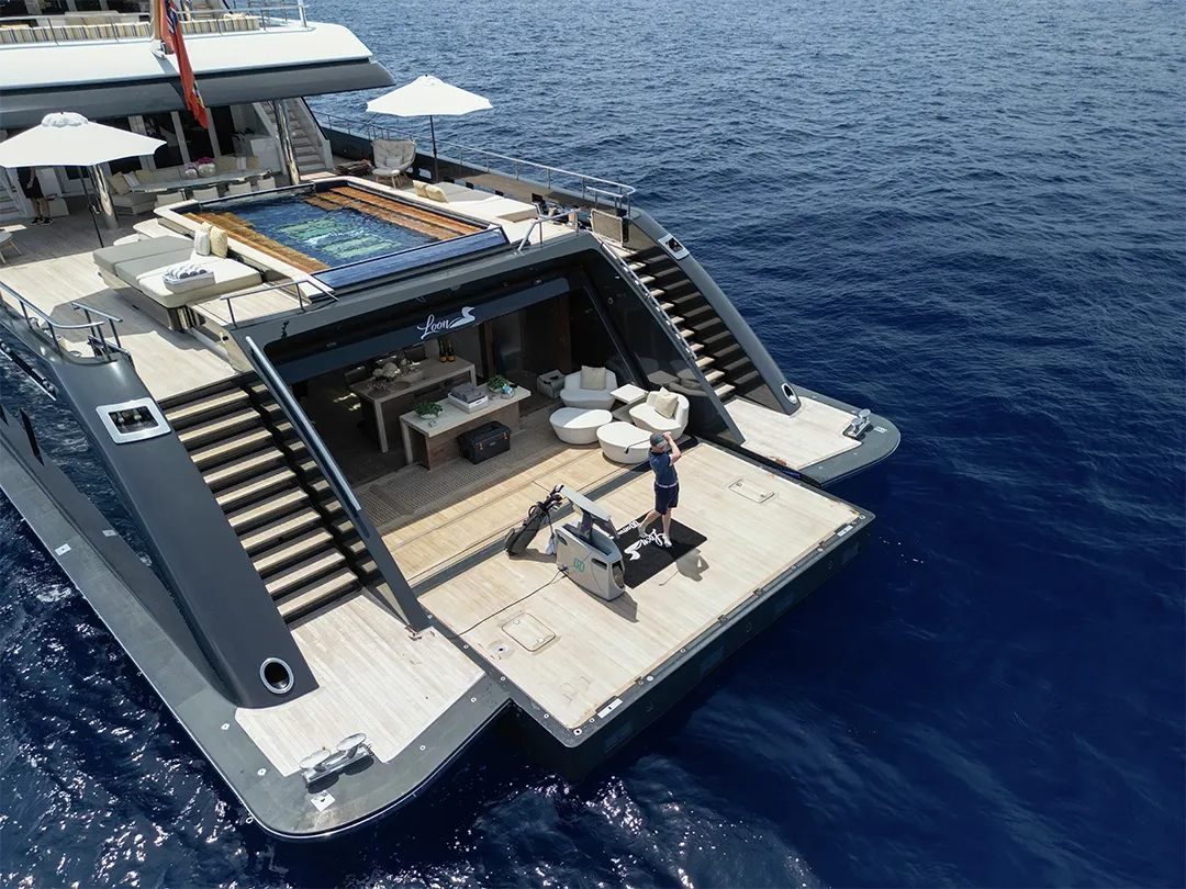 charter guest playing golf with off the Deck on a superyacht