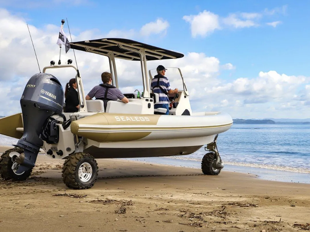 Superyacht crew and charter guests launching a Sealegs tender from a beach