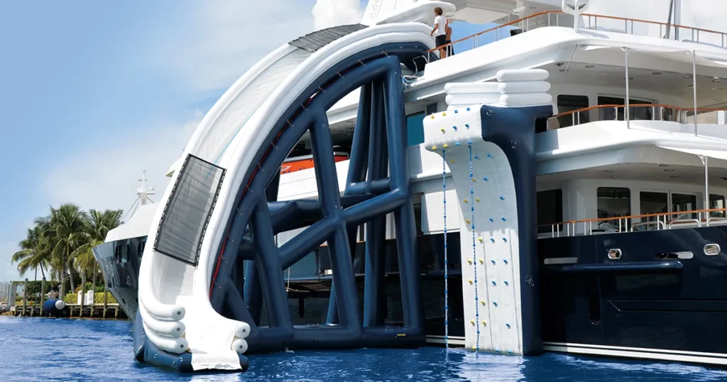 The inflatable climbing wall and curved yacht slide on charter superyacht Helios