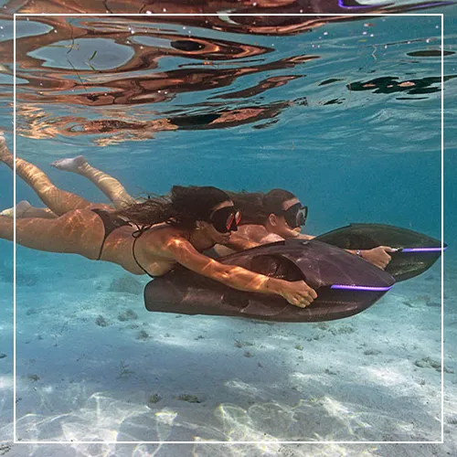 two charter guests sharing the fun with SeaNXT underwater scooters