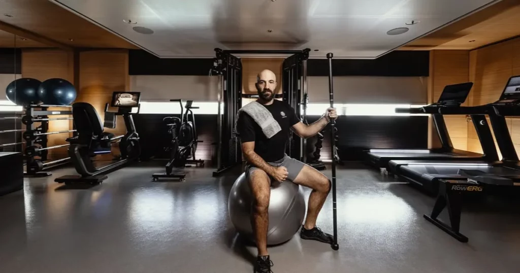 superyacht crew member in the gym of a luxury charter yacht @oceancoyacht